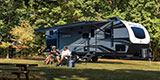 DGA Design Venture RV Stratus SR291VQB Travel Trailer with Models at Campsite Photography